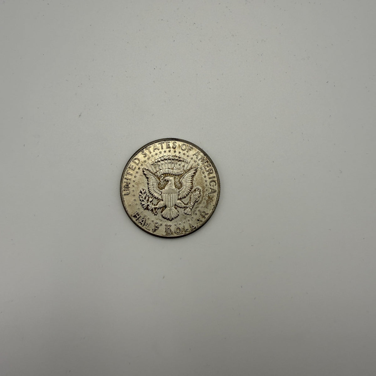1964 Kennedy half dollar - back (representative)