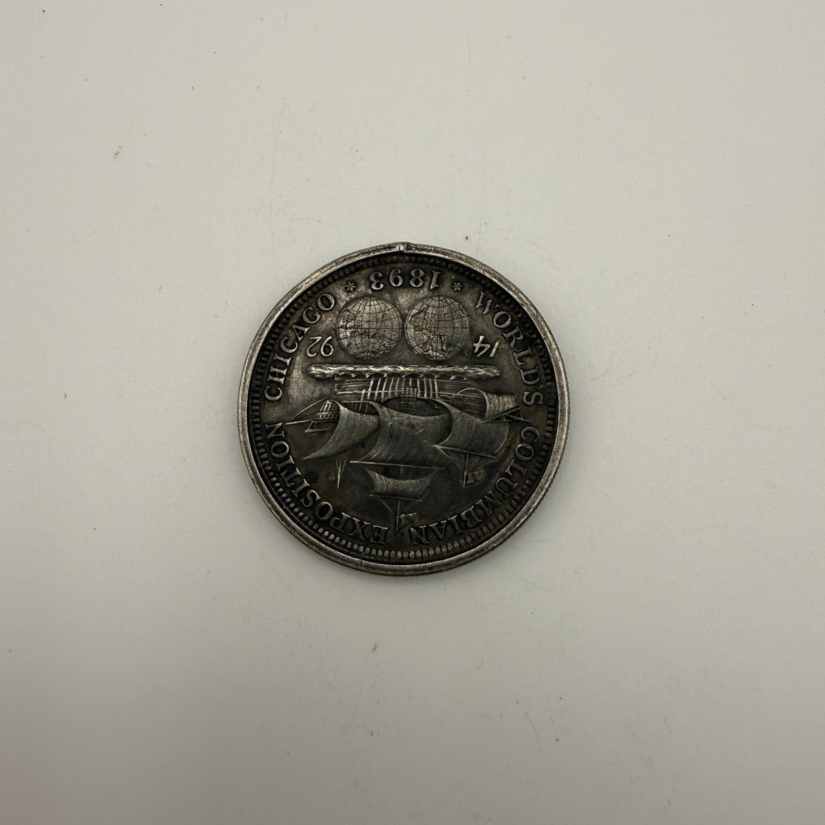 1893 Columbian Exposition half dollar, rim damage - back