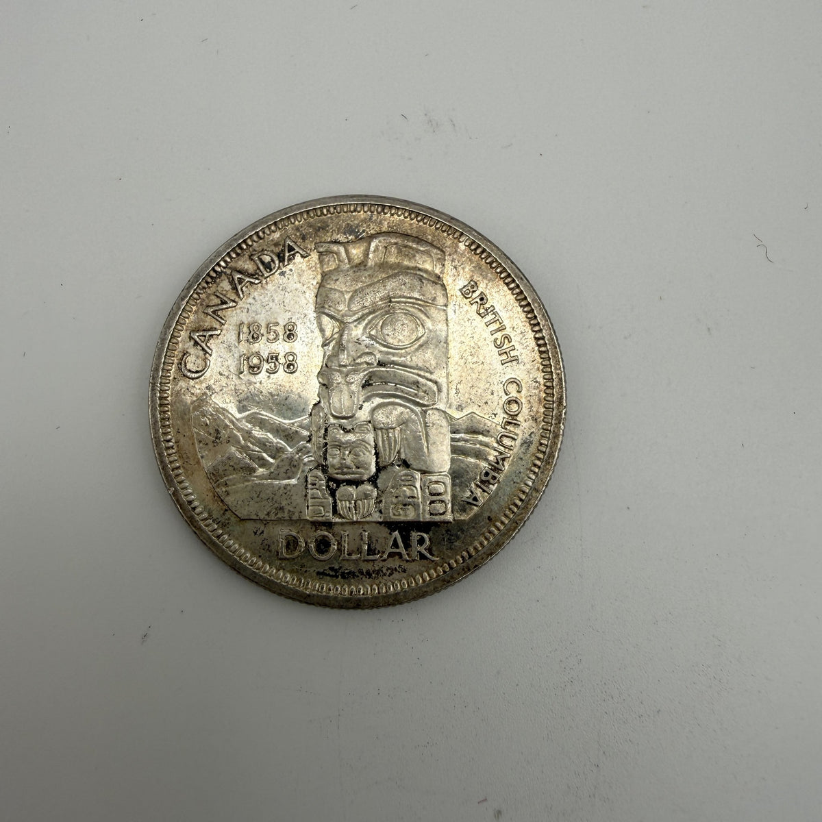 1958 Canada $1 British Columbia Centennial Totem Pole 80% Silver Dollar - front